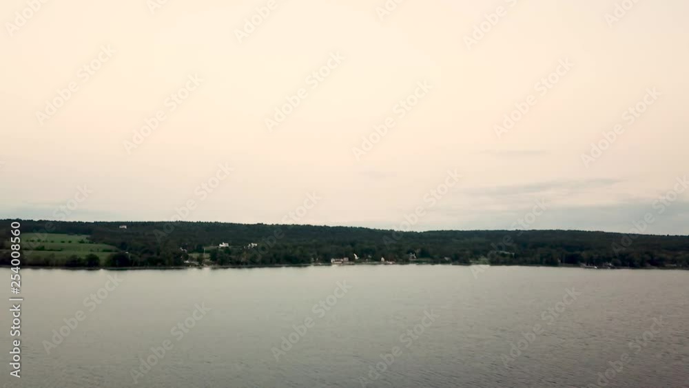 Drone flying towards shore at sunset Drone flying towards shore at sunset