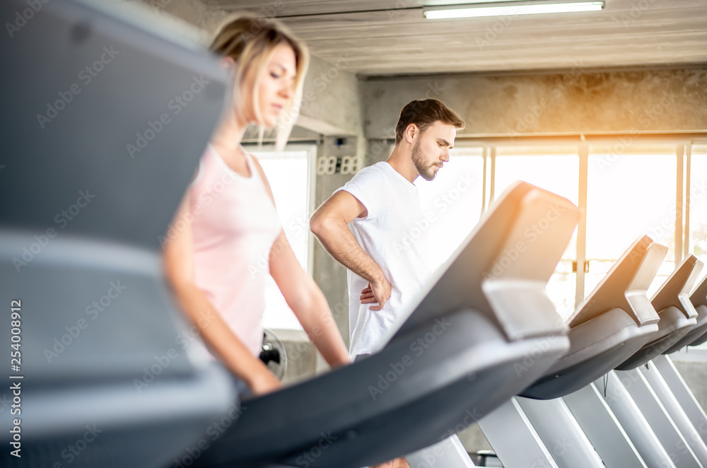 Obraz premium coach teaches correct using fitnes equipment,Portrait Fitness coaches are controlling the training equipment