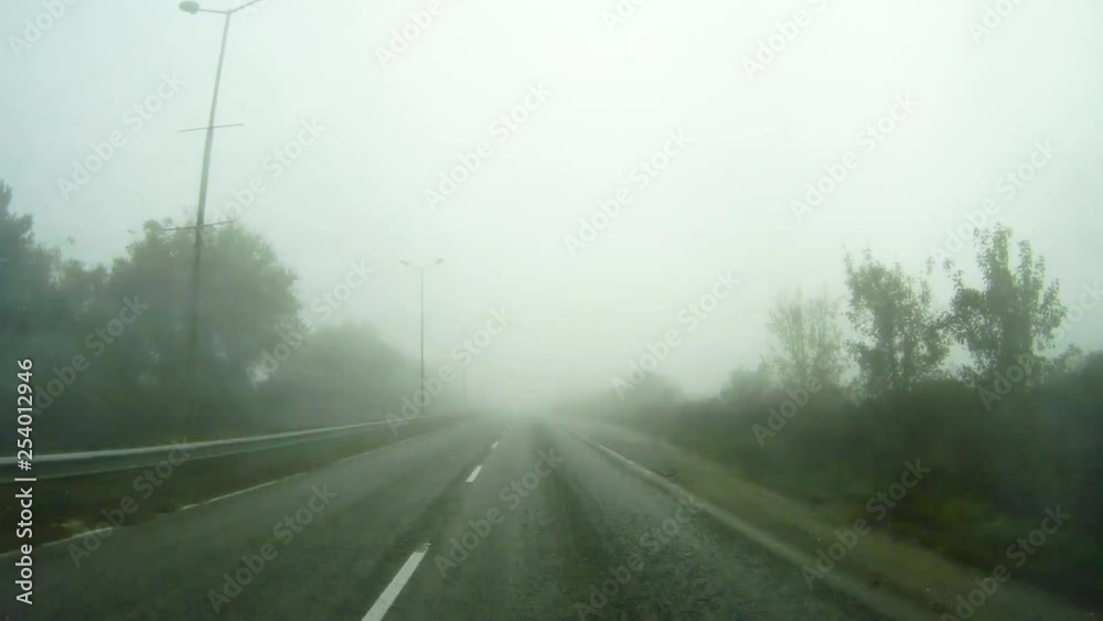 Car travels in fog and rain. Video background. Move forward.
