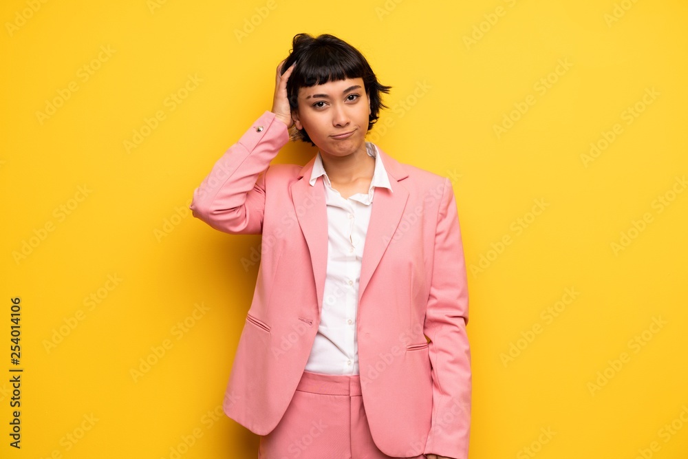 Modern woman with pink business suit with an expression of frustration and not understanding Modern woman with pink business suit with an expression of frustration and not understanding