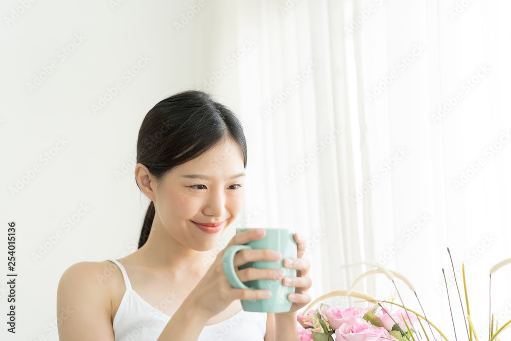 Portrait Asian woman relaxing on wooden chair with coffee at home Portrait Asian woman relaxing on wooden chair with coffee at home