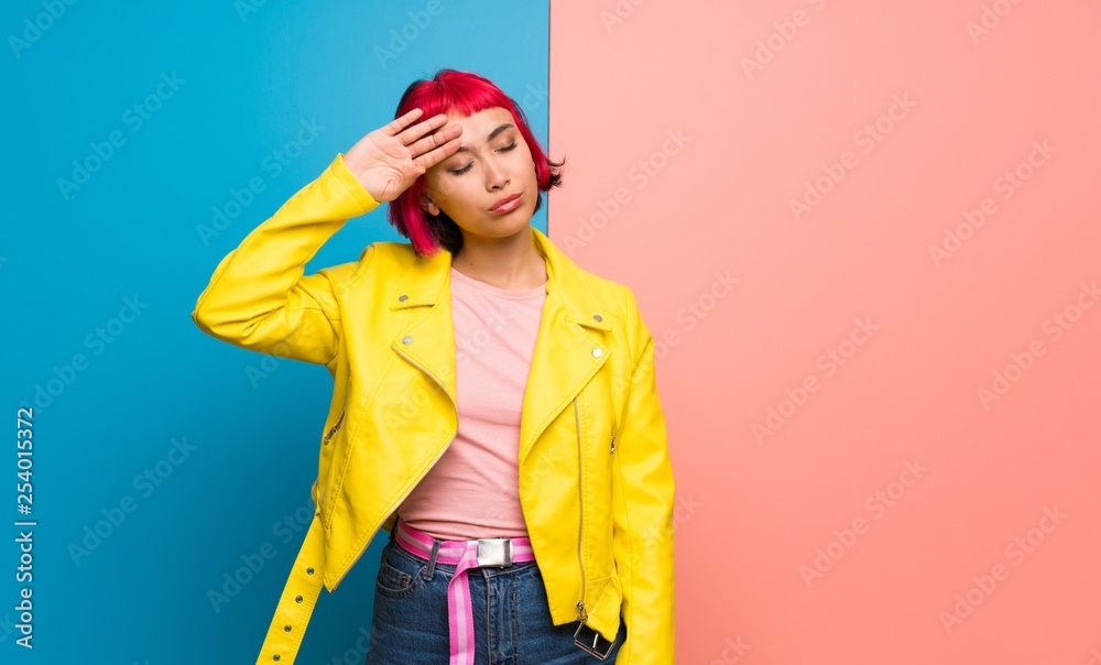 Young woman with yellow jacket with tired and sick expression Young woman with yellow jacket with tired and sick expression