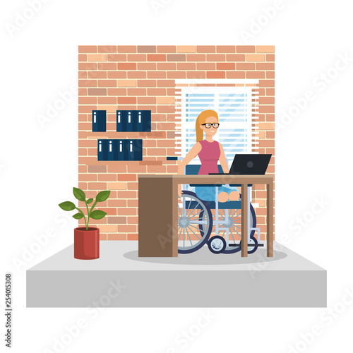 young woman in wheelchair working in the office