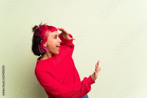 Young woman with red sweater is a little bit nervous and scared