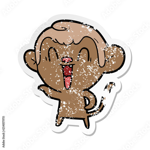 distressed sticker of a cartoon laughing monkey