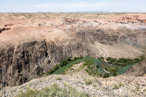 Charyn River flows within the Charyn Canyon and provides a fertile shore with its water. The canyon is also called valley of castles and is located east of Almaty in Kazakhstan. photo