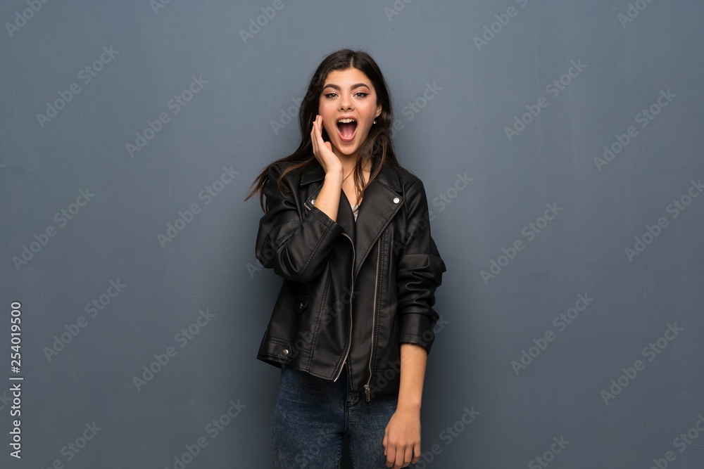 Teenager girl over grey wall with surprise and shocked facial expression Teenager girl over grey wall with surprise and shocked facial expression