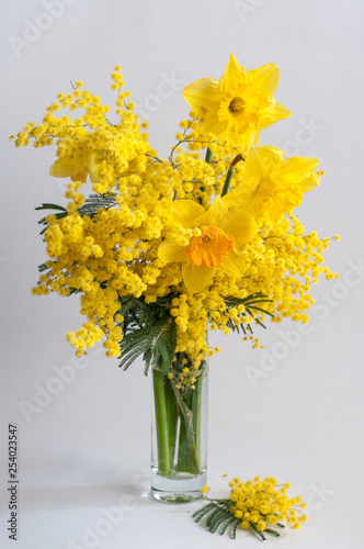 Bouquet of spring flowers in a vase. Mimosa and daffodils. © Ekaterina Usenko