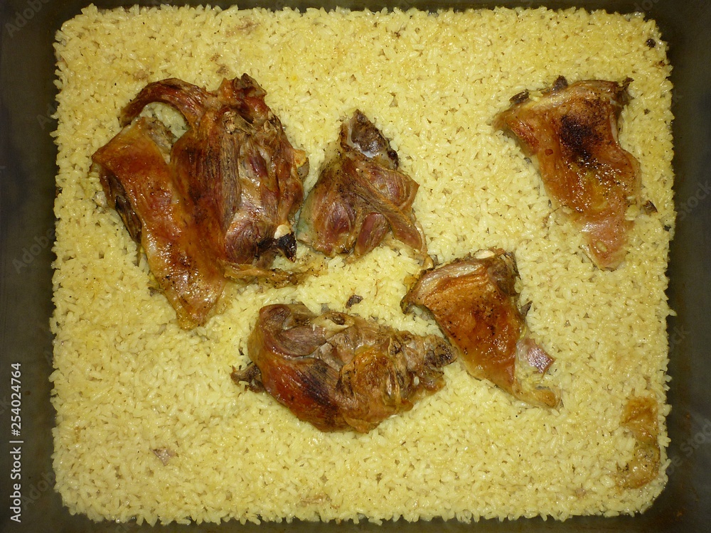 Φωτογραφία Top view of traditional Greek food of roasted pieces of lamb and yellow rice in