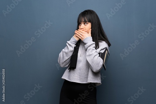 Young sport woman covering mouth and looking to the side