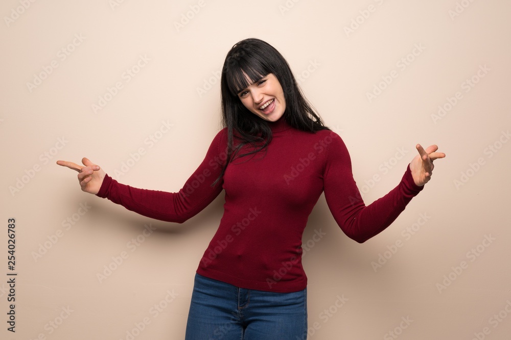 Young woman with red turtleneck proud and self-satisfied in love yourself concept Young woman with red turtleneck proud and self-satisfied in love yourself concept