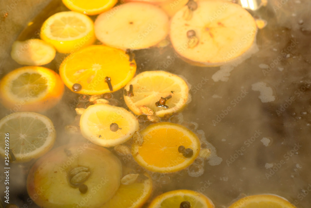 Boiling mulled wine with sliced fruit Boiling mulled wine with sliced fruit