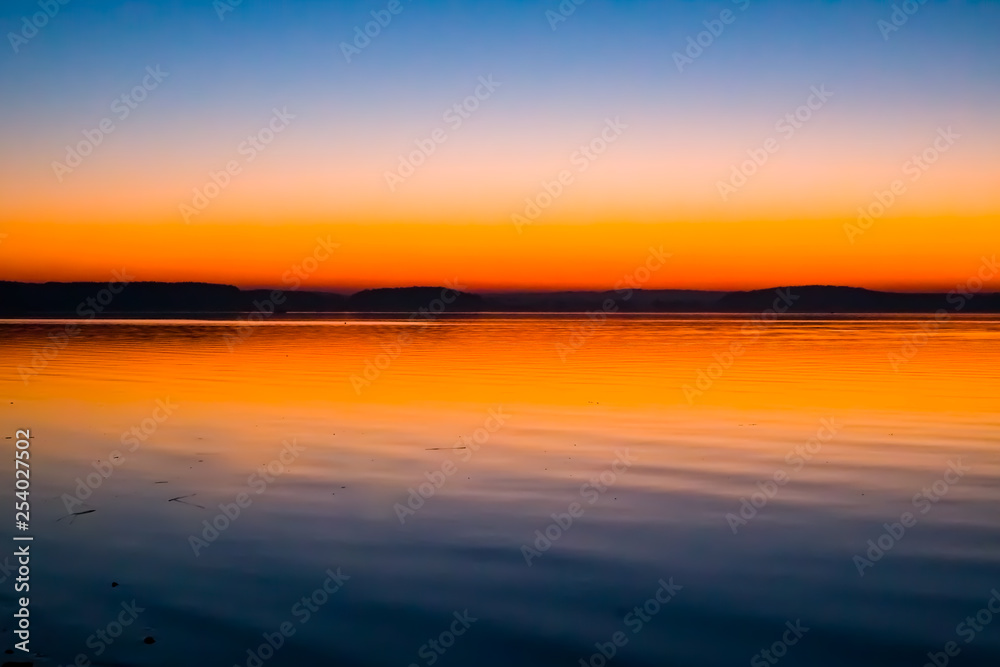 Incredible, bright sunset over the water. Minsk Sea, Belarus Incredible, bright sunset over the water. Minsk Sea, Belarus