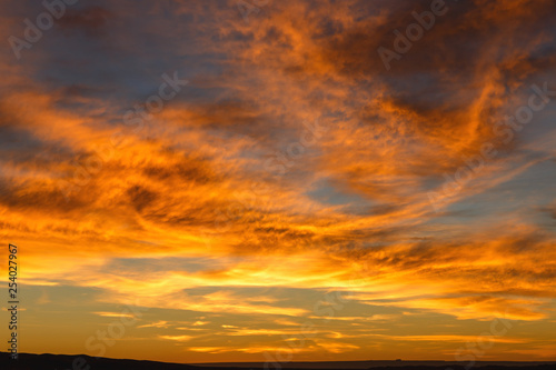 Colorful red sunset, Sahara desert, the sky at sunset with red clouds, Morocco.