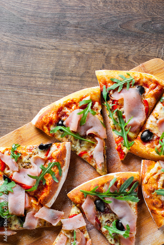 custom made wallpaper toronto digitalPizza with Mozzarella cheese, ham, pepper, olive, meat, Tomato sauce, Spices and Fresh arugula. Italian pizza on wooden background