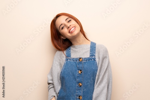 Young redhead woman over isolated background smiling
