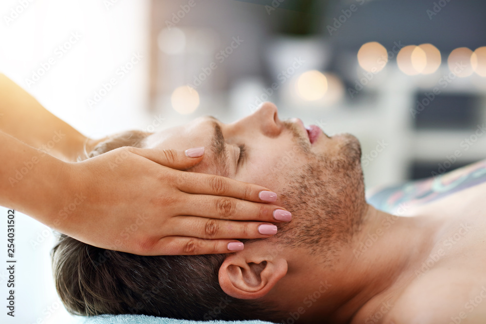 Handsome man having massage in spa salon StockFoto Adobe Stock
