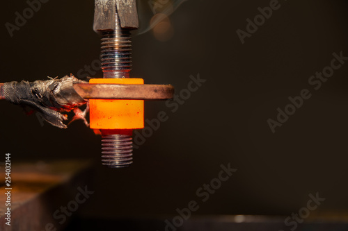 closeup calcining hot metal steel gear parts in a factory induction furnace with smoke