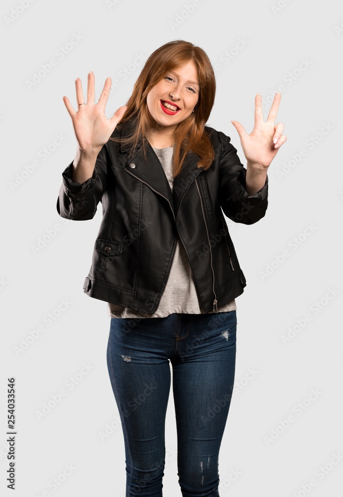 Young redhead woman counting eight with fingers over isolated grey background Young redhead woman counting eight with fingers over isolated grey background