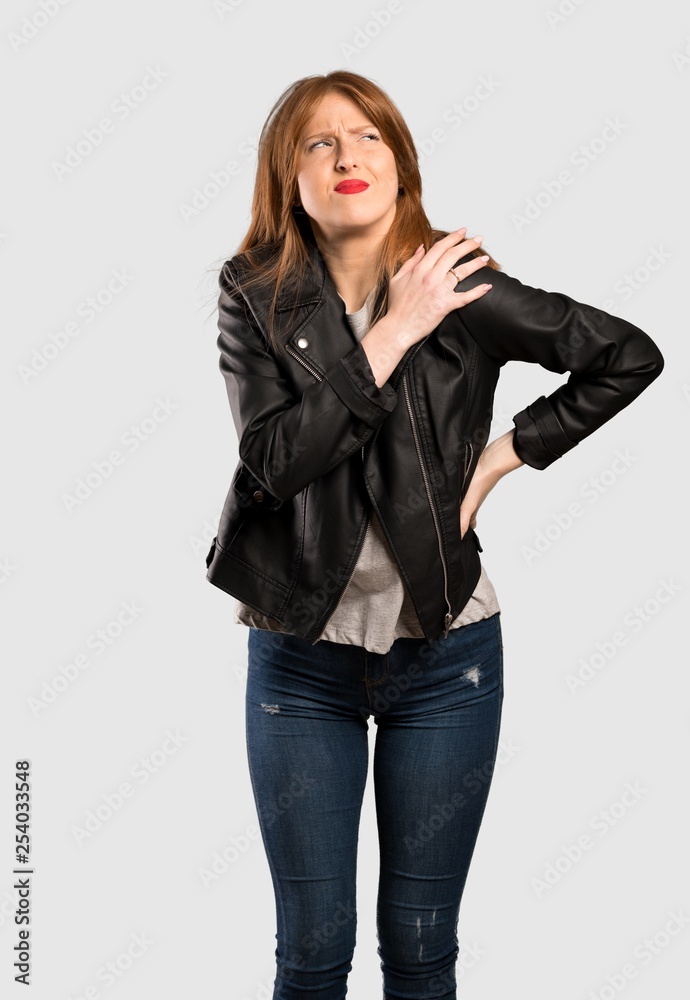 Young redhead woman suffering from pain in shoulder for having made an effort over isolated grey background Young redhead woman suffering from pain in shoulder for having made an effort over isolated grey background