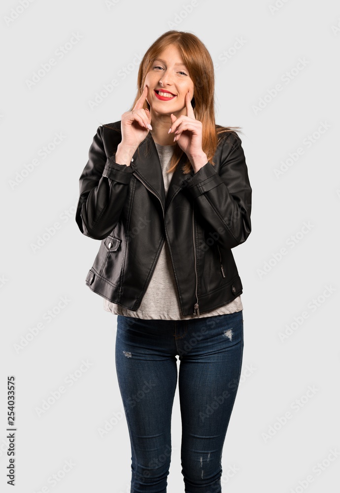 Young redhead woman smiling with a happy and pleasant expression over isolated grey background Young redhead woman smiling with a happy and pleasant expression over isolated grey background
