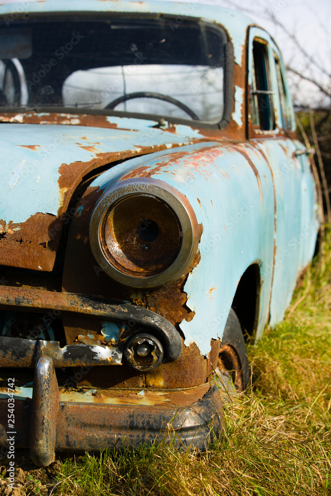Old, abandoned rusty car wreck front and lamp. Old, abandoned rusty car wreck front and lamp.