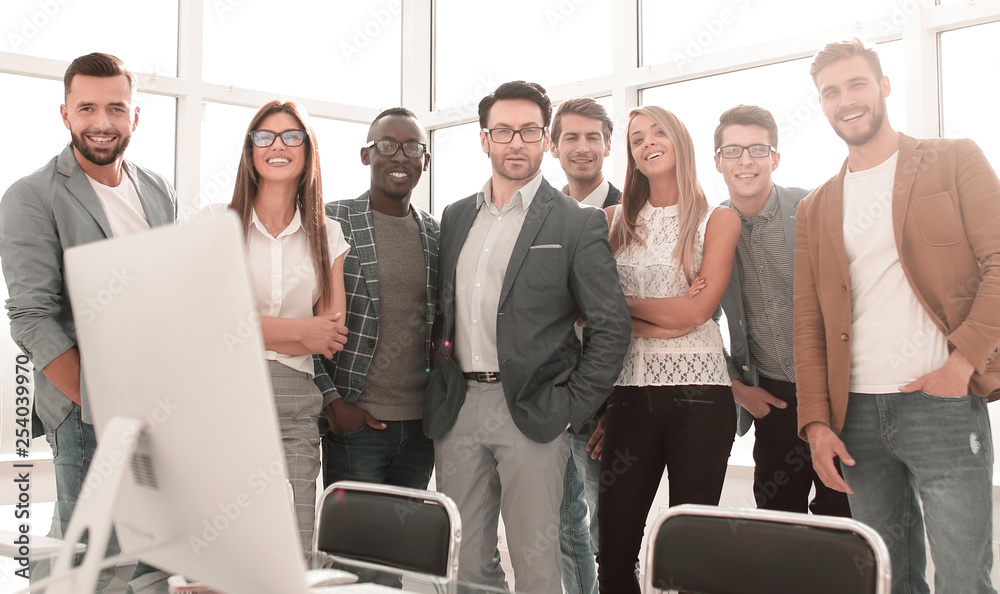 multinational business team standing in a bright office multinational business team standing in a bright office