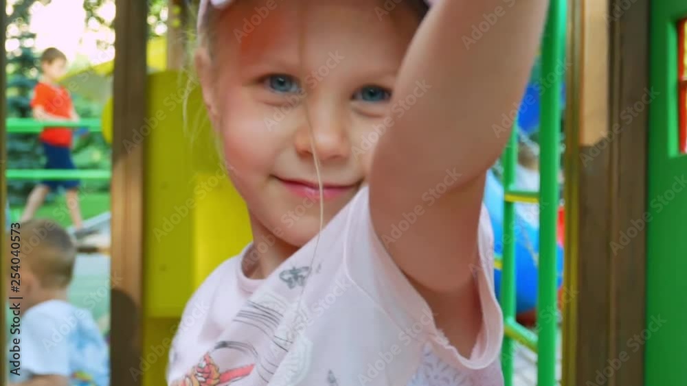 Little girl smiling at children playground Little girl smiling at children playground
