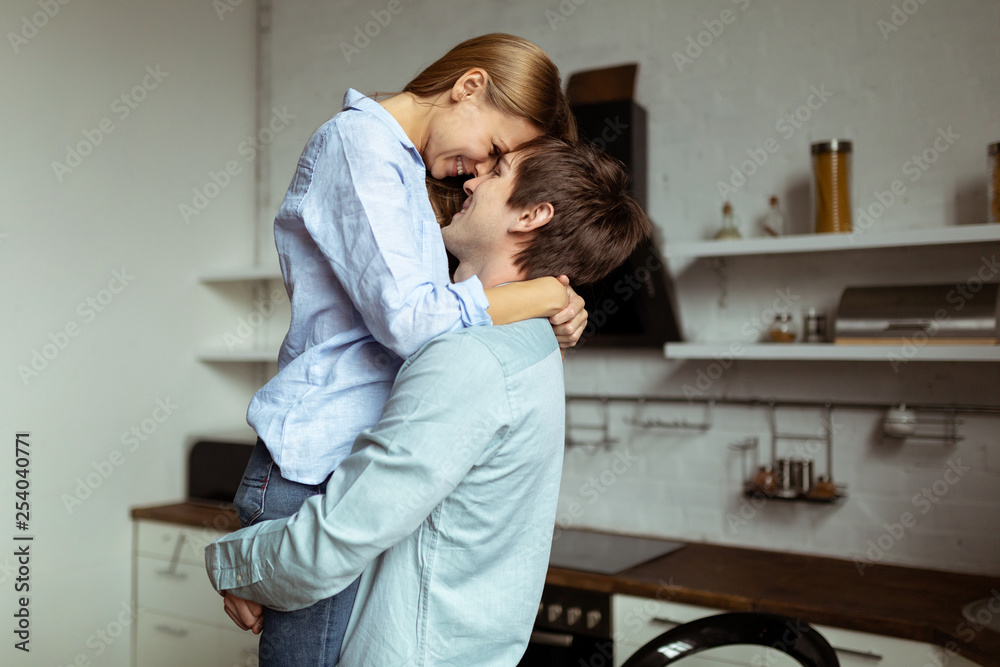 Romantic young couple in love spending time together in kitchen Romantic young couple in love spending time together in kitchen
