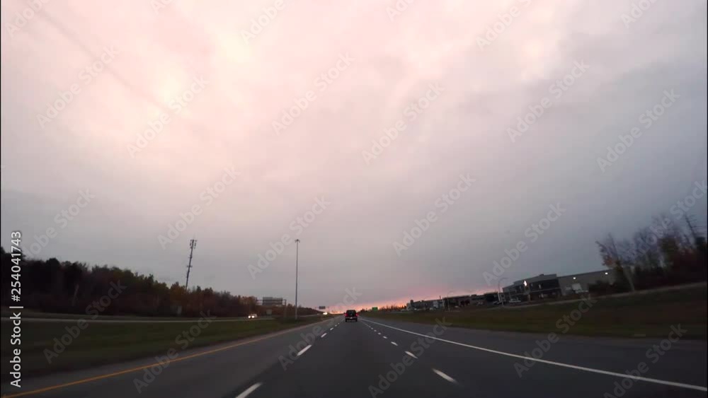 Car driving (drivers point of view) on a highway with clear skies near sunset time - autumn season. Car driving (drivers point of view) on a highway with clear skies near sunset time - autumn season.