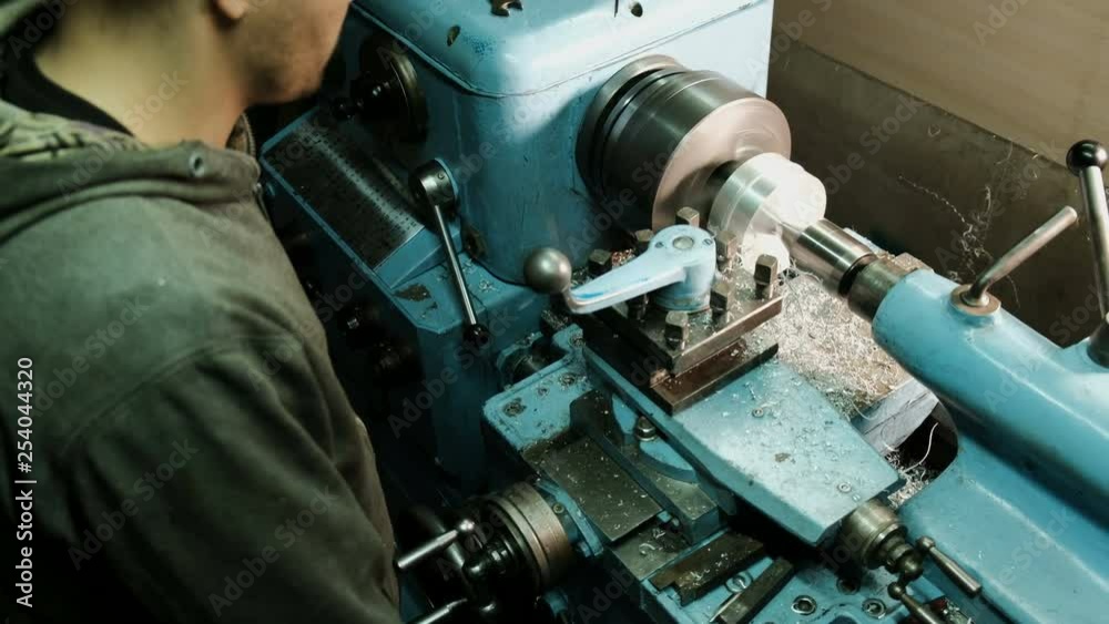 Turner is working on a turning lathe at the metal constructions factory. Metal industry Turner is working on a turning lathe at the metal constructions factory. Metal industry