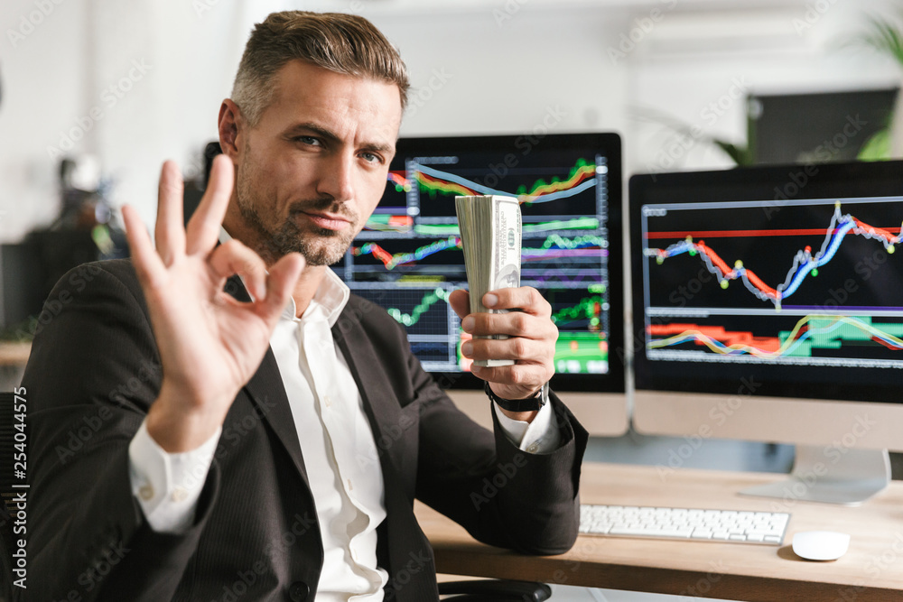 Businessman In Office With Money
