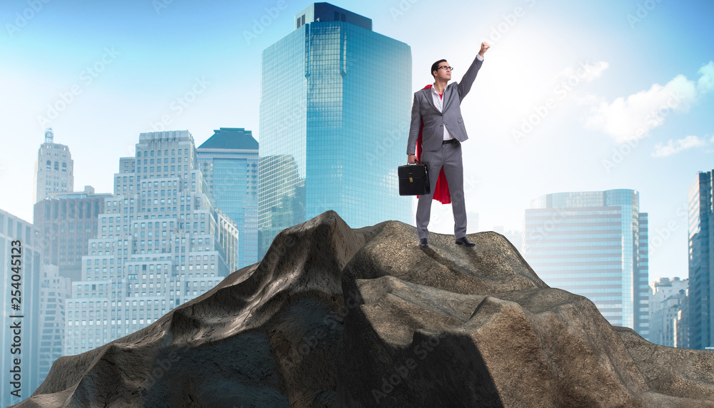 Superhero businessman on top of mountain Superhero businessman on top of mountain