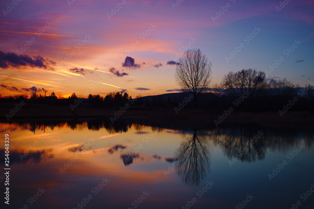 Beautiful red and blue colors and reflection after sunset over a lake