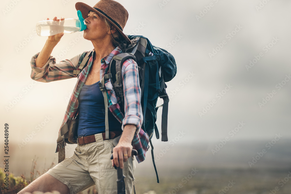 Portrait of a female hiker drinking water