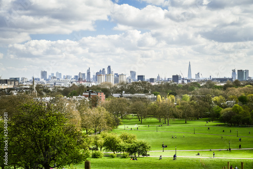 People enjoying the clear view of central London,as well as Hampstead from the summit of Primrose Hill.Primrose Hill is located on the northern side of Regent's Park. 