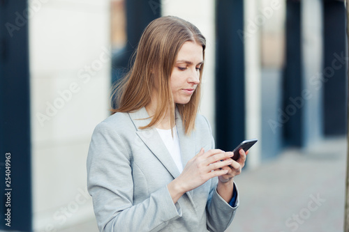 Young woman wearing casual using smartphone outdoor