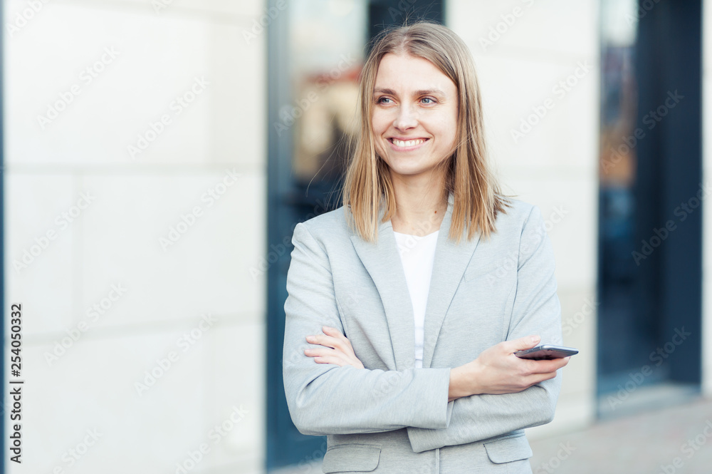 Beautiful young businesswoman using smartphone Beautiful young businesswoman using smartphone