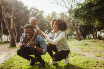 Happy young family enjoying at the park