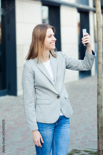 Beautiful young businesswoman using smartphone