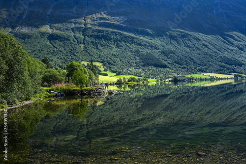 Amazing landscape with mountains and forests reflecting in Eidsvatnet lake near Geirangerfjord, Sunnmore, More og Romsdal, Norway photo