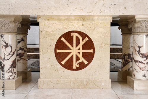 Christian Chi Rho symbol for first two Greek letters of Christ inlaid on the marble altar of a Roman Catholic church in Toronto photo