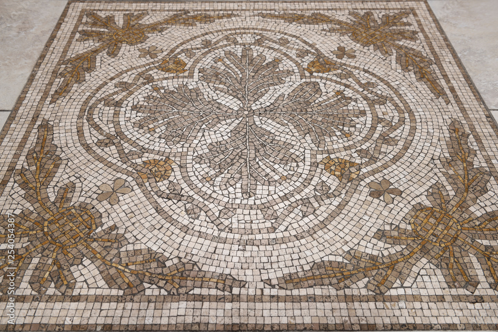 Flower design Cross of Saint Florian mosaic tiles on the floor of a Toronto Roman Catholic church