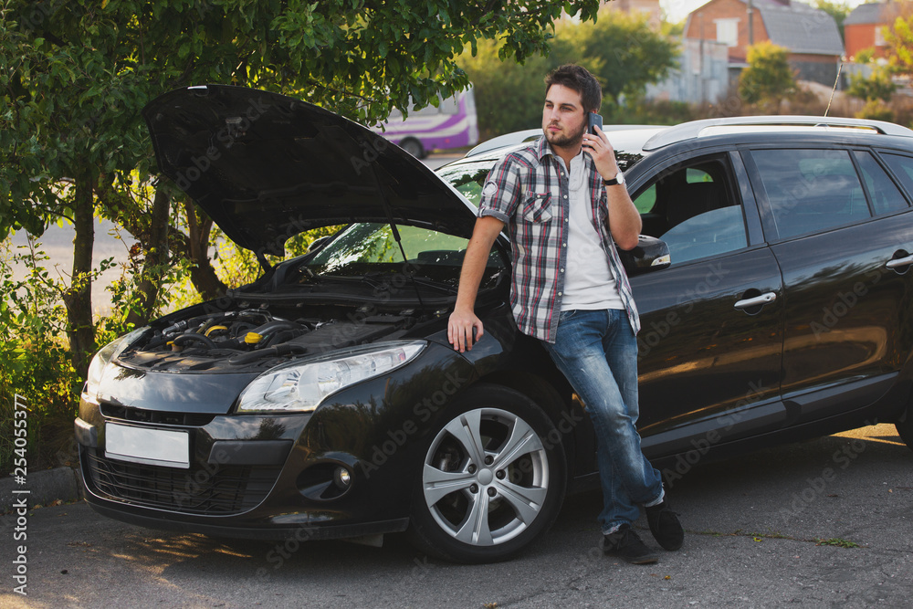 Desperate man calling for assistance after breaking down in a car park Desperate man calling for assistance after breaking down in a car park