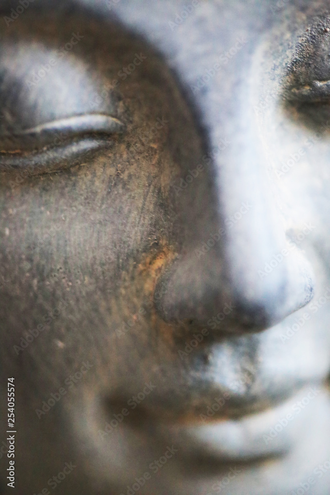 Fototapeta premium Buddha face close up shot. Buddhist religion concept idea