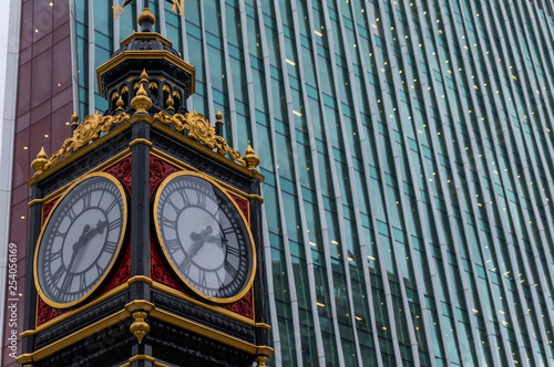  Little Ben Clock Tower in London near Victoria Station, with skyline in background. First erected 1892. Cast iron.  photo