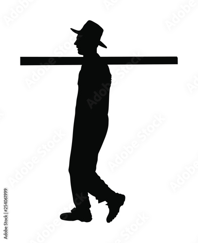 Worker carries a beam on his shoulder vector silhouette illustration. Construction man walking. Farmer with leverage on shoulder.