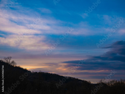 Beautiful landscape in the mountains at sunset. View of colorful sky with amazing clouds.