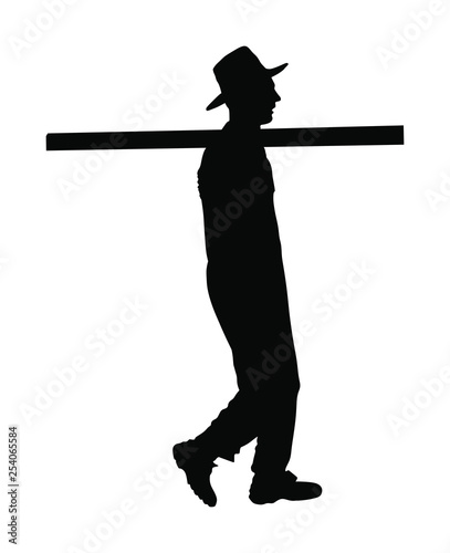 Worker carries a beam on his shoulder vector silhouette illustration. Construction man walking.