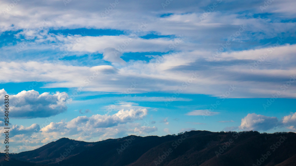 Obraz premium Beautiful landscape in the mountains at sunset. View of colorful sky with amazing clouds.
